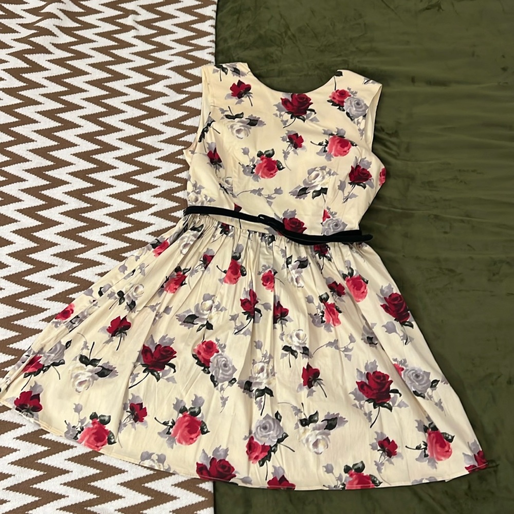 Cream color with rose patterns. This dress to fit up to size 10/12.